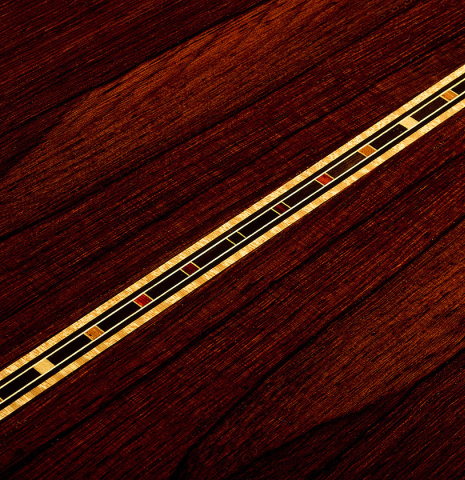 The back center seam with inlay of a 2026 So Kimishima “Sol” classical guitar made of cedar and African rosewood