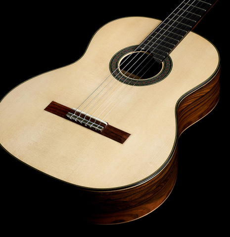 The soundboard of a 2025 Evan Kingma classical guitar made of spruce and ziricote