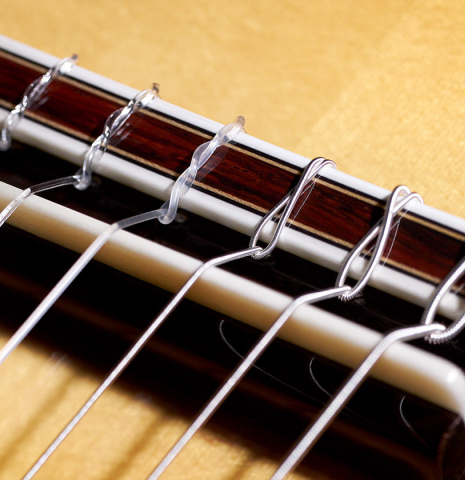 The bridge, tie block and saddle of a 2023 Sakurai-Kohno "Professional-J" classical guitar made with spruce and CSA rosewood.
