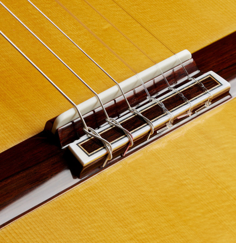 The bridge, tie-block and saddle of a 2024 Sakurai-Kohno "Professional-J" classical guitar made with spruce and African rosewood.