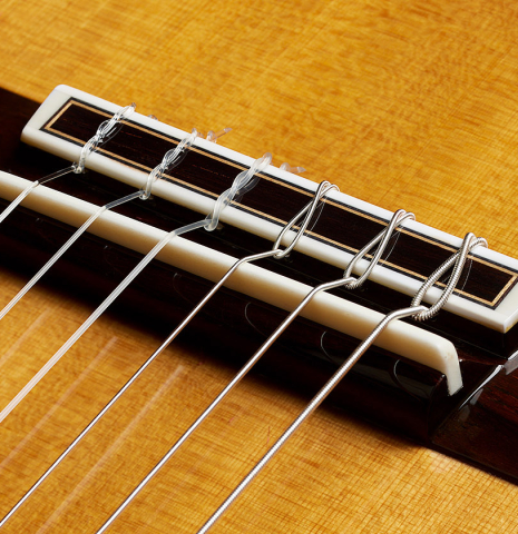 The bridge, tie-block and saddle of a 2025 Sakurai-Kohno "Professional-J" classical guitar made of cedar and African rosewood