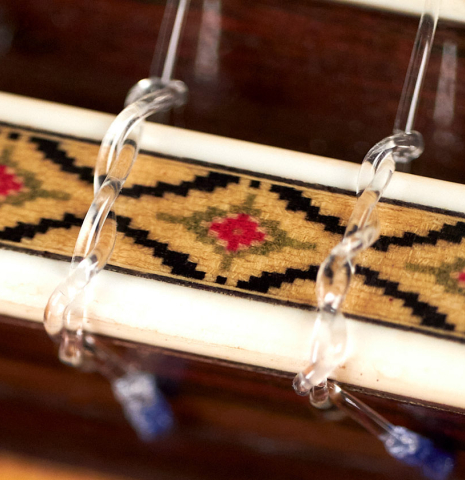 A close-up of the bridge of a 1982 Masaru Kohno &quot;Concert&quot; classical guitar made of spruce and Indian rosewood