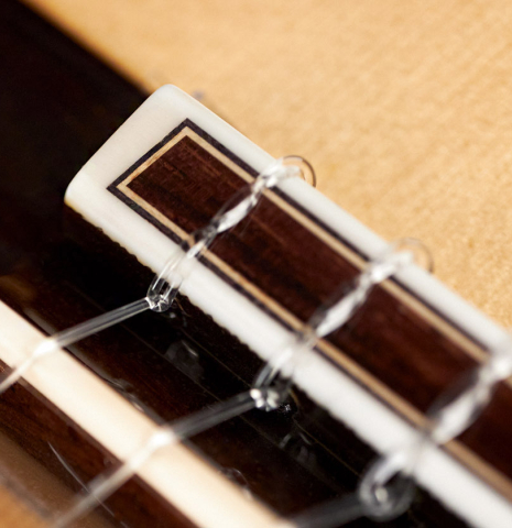 The bridge, tie block and saddle of a 2005 Sakurai-Kohno "Professional-J" classical guitar made with spruce and CSA rosewood.