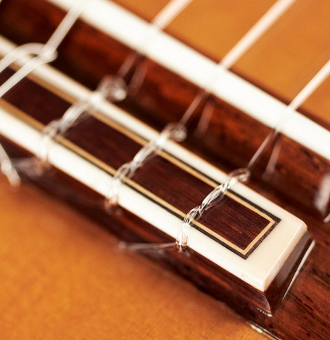 The bridge, tie-block and saddle of a 2009 Sakurai-Kohno "Professional-J" classical guitar made of cedar and CSA rosewood