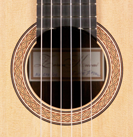 The rosette of a 2015 Zoran Kuvac classical guitar made with cedar and African rosewood
