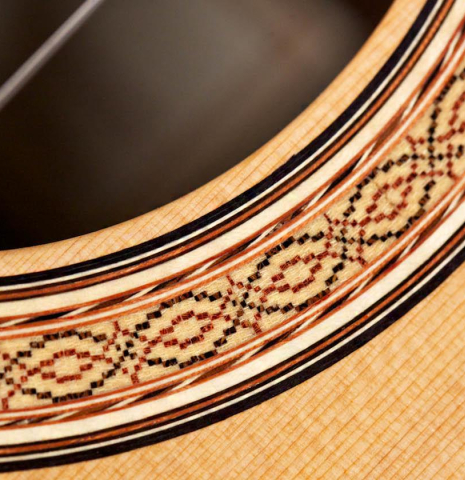 The rosette of a 2015 Zoran Kuvac classical guitar made with cedar and African rosewood