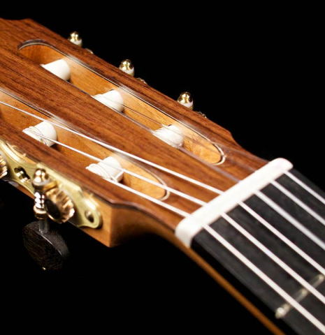 The headstock and machine heads of a 2015 Zoran Kuvac classical guitar made with cedar and African rosewood