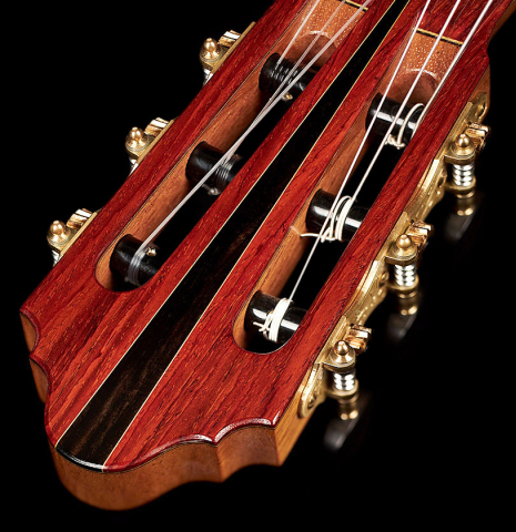 The headstock and tuning machines of a 2023 Zoran Kuvac classical guitar made of cedar and cocobolo.