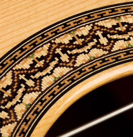 The soundboard and rosette detail of a 2004 Bert Kwakkel "Merula 640" classical guitar made of spruce and CSA rosewood