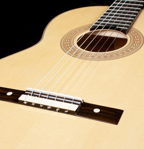 The bridge and soundboard of a La Cañada "Model 17" classical guitar made of spruce and maple