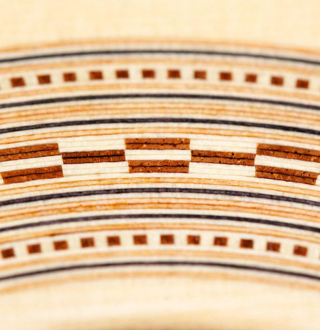 The close-up of a rosette of a La Cañada "Model 115" classical guitar made with spruce and granadillo