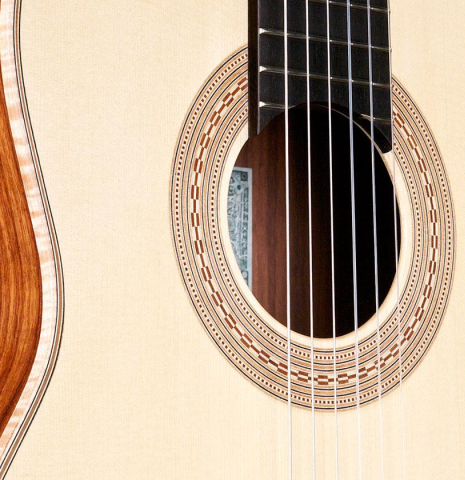 The soundboard and side of a La Cañada &quot;Model 115&quot; classical guitar made with spruce and granadillo