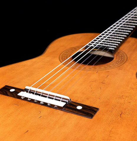 The bridge of a La Cañada "Model 17A" classical guitar made of spruce and Granadillo