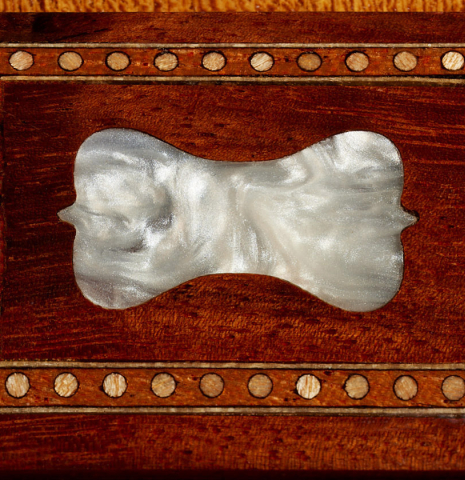 The MOP bridge inlay of a La Cañada "Model 17A" classical guitar made of spruce and granadillo