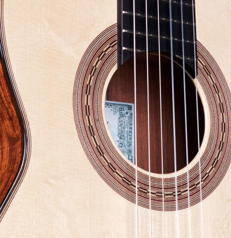 The soundboard and rosette of a La Cañada "Model 17" classical guitar made of spruce and Granadillo