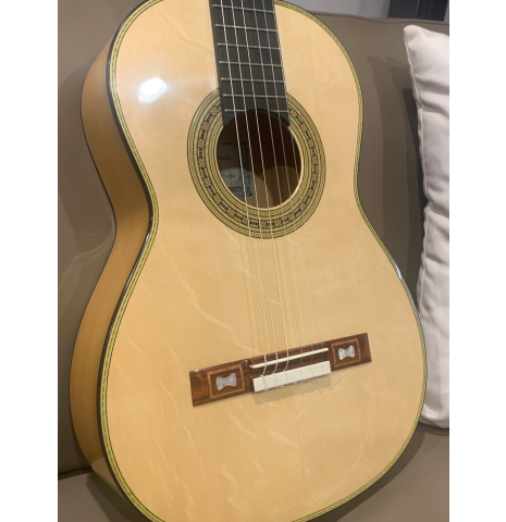 The actual front of the 2025 La Cañada "Model 17" classical guitar made of spruce and cypress being auctioned