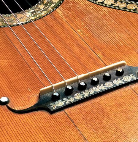 The bridge, tie-block and saddle of a c. 1845-1875 French Romantic guitar “1844 Lacôte” classical guitar made of spruce and pear wood