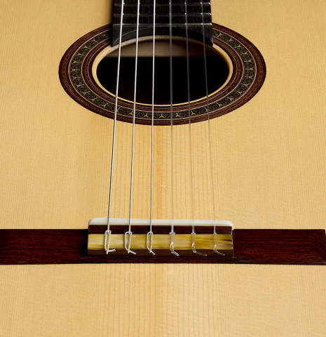 The soundboard and bridge of a 2026 Nicolás Lamoureux classical guitar made of spruce and Indian rosewood
