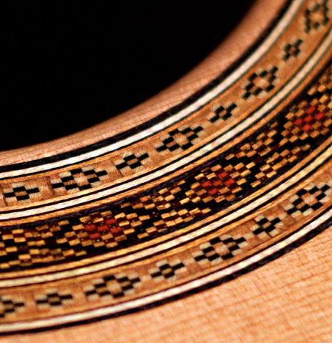 The rosette of a 2022 Paula Lazzarini classical guitar made of cedar and Indian rosewood