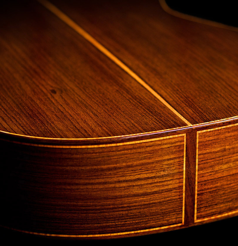 The back and sides of a 2022 Paula Lazzarini classical guitar made of cedar and Indian rosewood