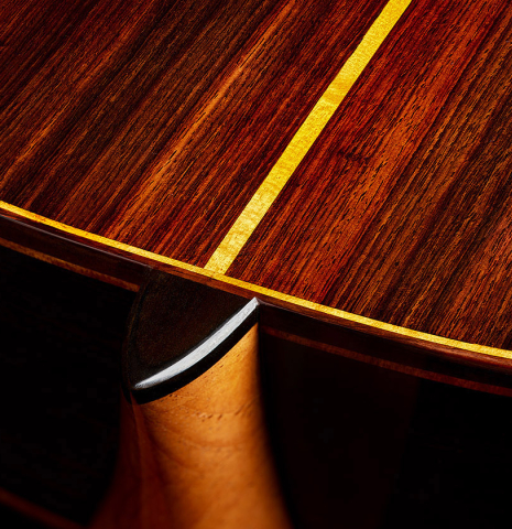 The heel, back binding and purfling of a 2025 Paula Lazzarini classical guitar made of cedar and Indian rosewood