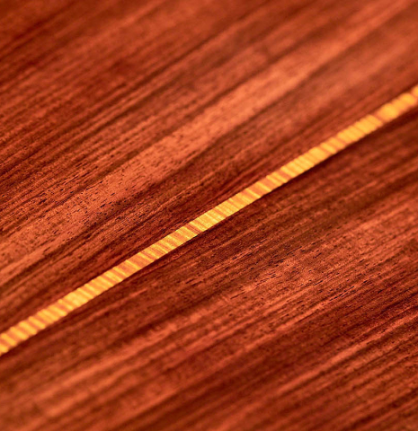 The back and center purfling of a 2021 Paula Lazzarini classical guitar made of cedar and Indian rosewood