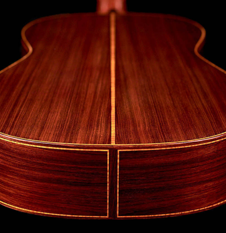 The back and sides of a 2021 Paula Lazzarini classical guitar made of cedar and Indian rosewood