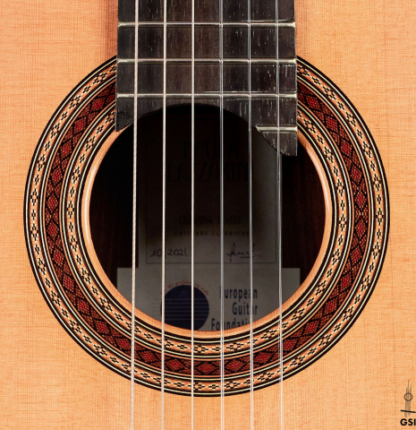 The rosette of a 2021 Paula Lazzarini classical guitar made of cedar and Indian rosewood