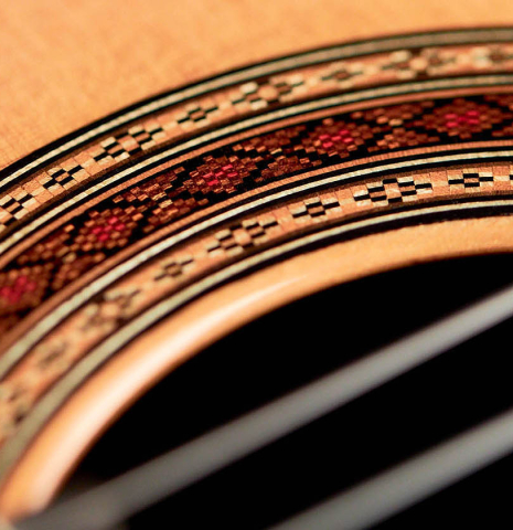 The rosette of a 2021 Paula Lazzarini classical guitar made of cedar and Indian rosewood