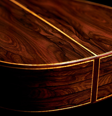 The back and sides at the foot of a 2023 Paula Lazzarini classical guitar made of cedar and ziricote