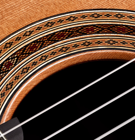 Detailed close-up of the rosette of a 2024 Paula Lazzarini "Roma Guitar Expo" classical guitar made of cedar and cocobolo