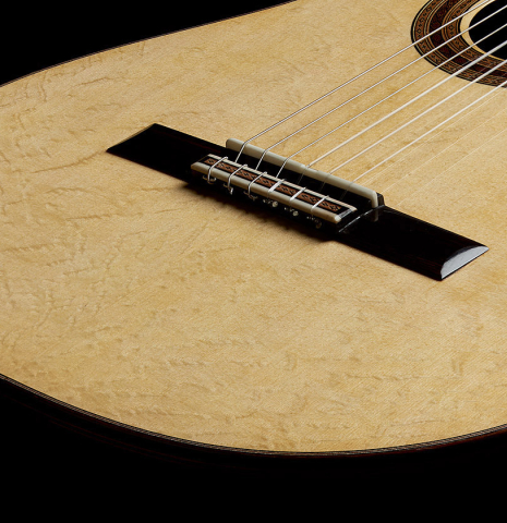 The bridge, tie-block and saddle of a 2025 Paula Lazzarini "Limited Edition - REG 2025" classical guitar made of spruce and African rosewood