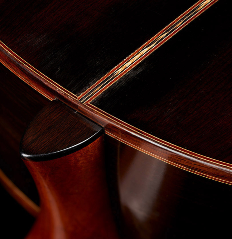 The heel, back binding and purfling of a 2014 Garrett Lee classical guitar made of spruce and CSA rosewood