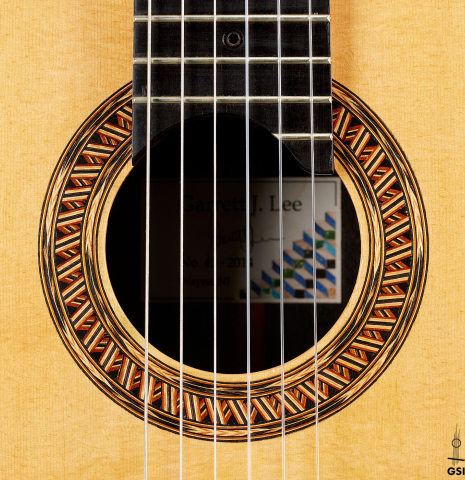 The rosette of a 2014 Garrett Lee classical guitar made of spruce and CSA rosewood