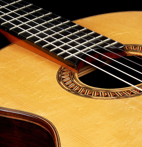The top and elevated fingerboard of a 2014 Garrett Lee classical guitar made of spruce and CSA rosewood