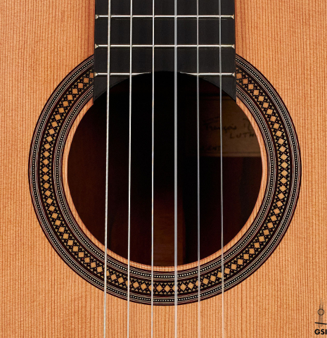 The rosette of a 2022 Francois Leonard classical guitar made of cedar and African rosewood