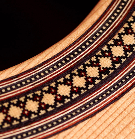 The rosette of a 2022 Francois Leonard classical guitar made of cedar and African rosewood