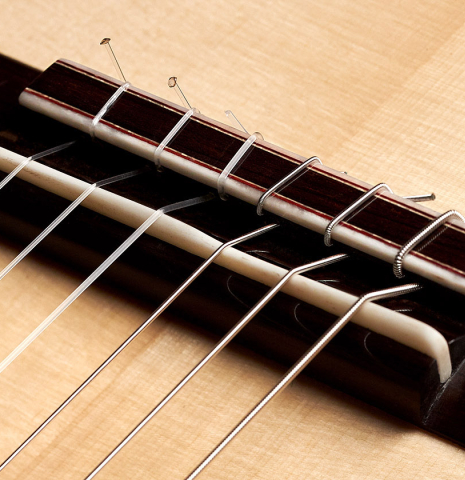 The bridge and tie block of a 2022 Francois Leonard classical guitar made of spruce and African rosewood