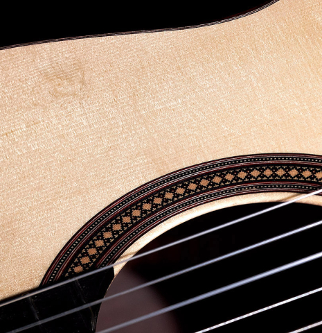 The soundboard and rosette of a 2022 Francois Leonard classical guitar made of spruce and African rosewood