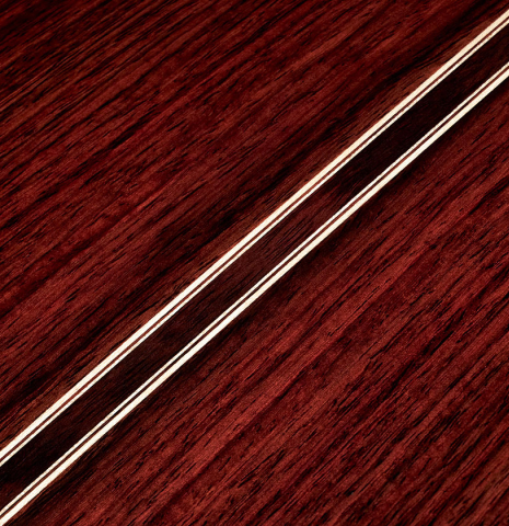 Detail of the back center seam and purfling of a 2023 Valerio Licari classical guitar made with spruce and Indian rosewood