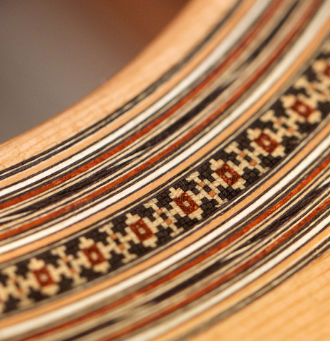 Closeup of the rosette of a 2021 Bertrand Ligier classical guitar made of cedar and Indian rosewood