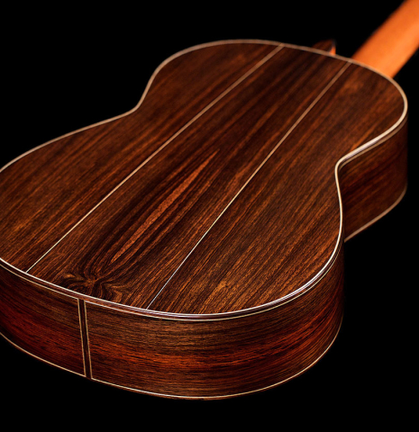The back and sides of a 2021 Bertrand Ligier classical guitar made of cedar and Indian rosewood