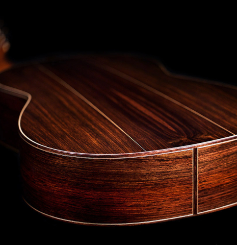 The back and sides at the foot of a 2021 Bertrand Ligier classical guitar made of cedar and Indian rosewood
