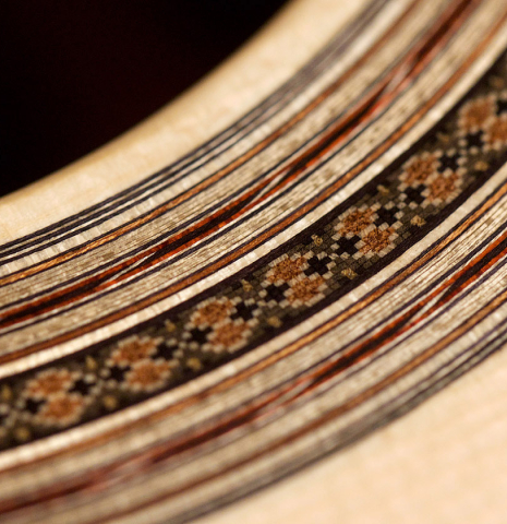 A close-up fo the rosette of a 2021 Bertrand Ligier classical guitar made of spruce and African rosewood