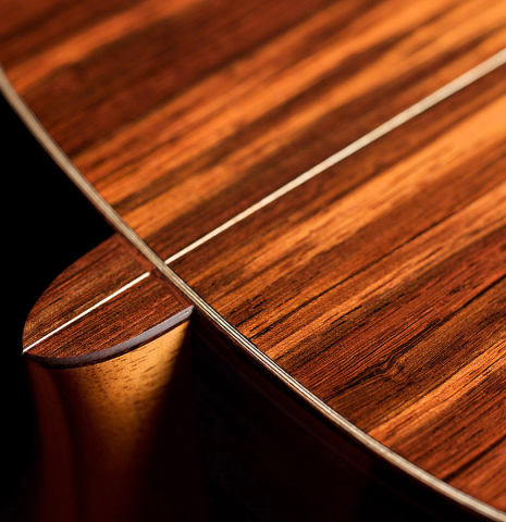A close-up of the heel of a 2021 Bertrand Ligier classical guitar made of spruce and African rosewood