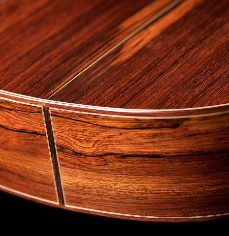 The back and sides of a 2021 Bertrand Ligier classical guitar made of spruce and African rosewood