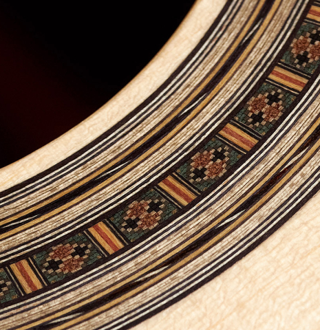 A close-up of the rosette of a 2023 Bertrand Ligier classical guitar made of spruce and African rosewood