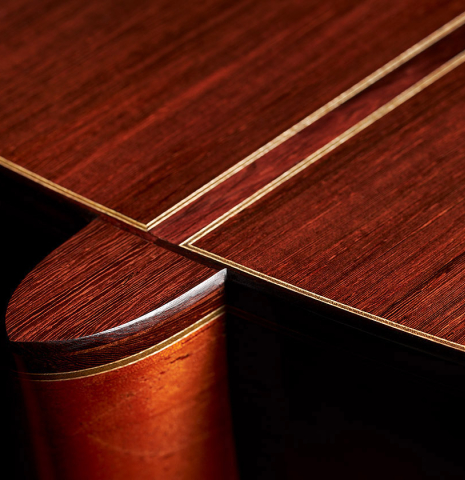 A close-up of the heel of a 2023 Bertrand Ligier classical guitar made of spruce and African rosewood