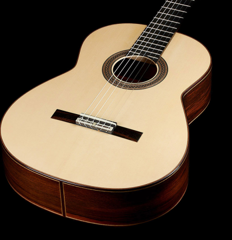 The soundboard of a 2024 Bertrand Ligier classical guitar made of spruce and African rosewood