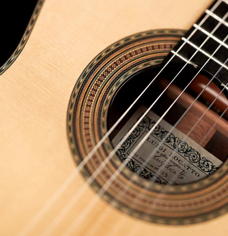 The soundboard and rosette of a 2023 Luigi Locatto classical guitar made of spruce and CSA rosewood